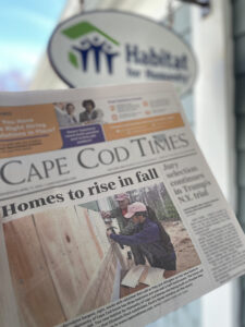 Image of Cape Cod Times Newspaper being held up