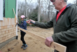Cape Cod Times Images by Merrily Cassidy, Image of Volunteer Bob Lodi and Future Homeowner Bernalynn Sargent shingling at Phoebe Way
